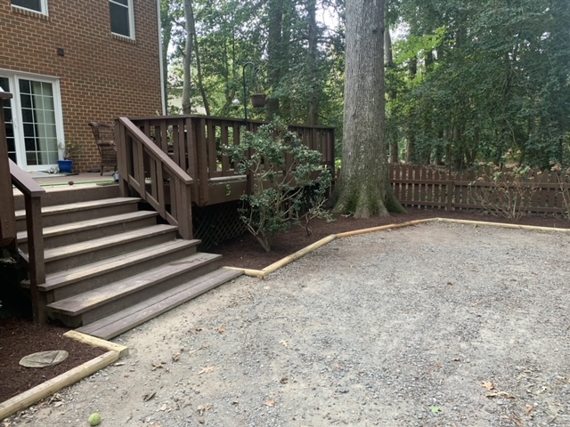 Improved backyard landscape beside a home