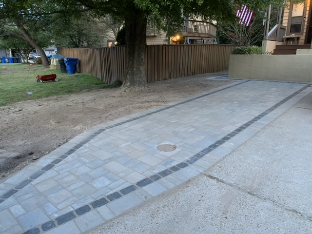 Paver driveway section beside an existing concrete surface