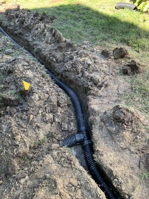 Perforated drainage pipe installed in a Hampton Roads yard